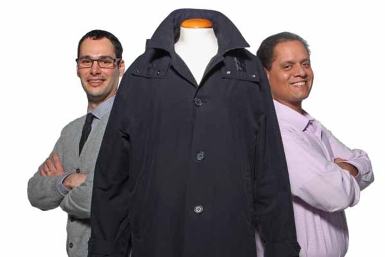 Jacob Hurwitz, left, and David Neill, right are partners in American Trench and are seen here with one of their trench coats. The intriguing tale of two local guys starting a trench-coat manufacturing company, and the lengths they've gone to ensure that the manufacturing stays in the U.S. -- mostly in New Jersey. Key to their venture is raising $15,000 by the end of January through the online funding platform that more and more small-business owners are turning to for start-up capital: Kickstarter. Jacob Hurwitz and David Neill, partners in American Trench, MASTRULL14 01/04/2013 ( MICHAEL BRYANT / Staff Photographer )