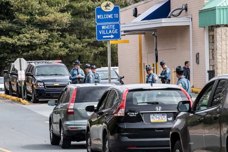 Delaware State Troopers block the the entrance and ask Pennsylvania drivers to turn around and not enter the Northtowne Plaza shopping center in Claymont.