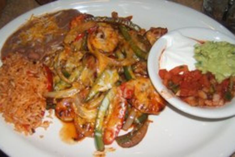 The shrimp fajita at Tortilla Press Cantina comes with sautéed peppers, onions and tomatoes, and is topped with a Mexican barbecue sauce.