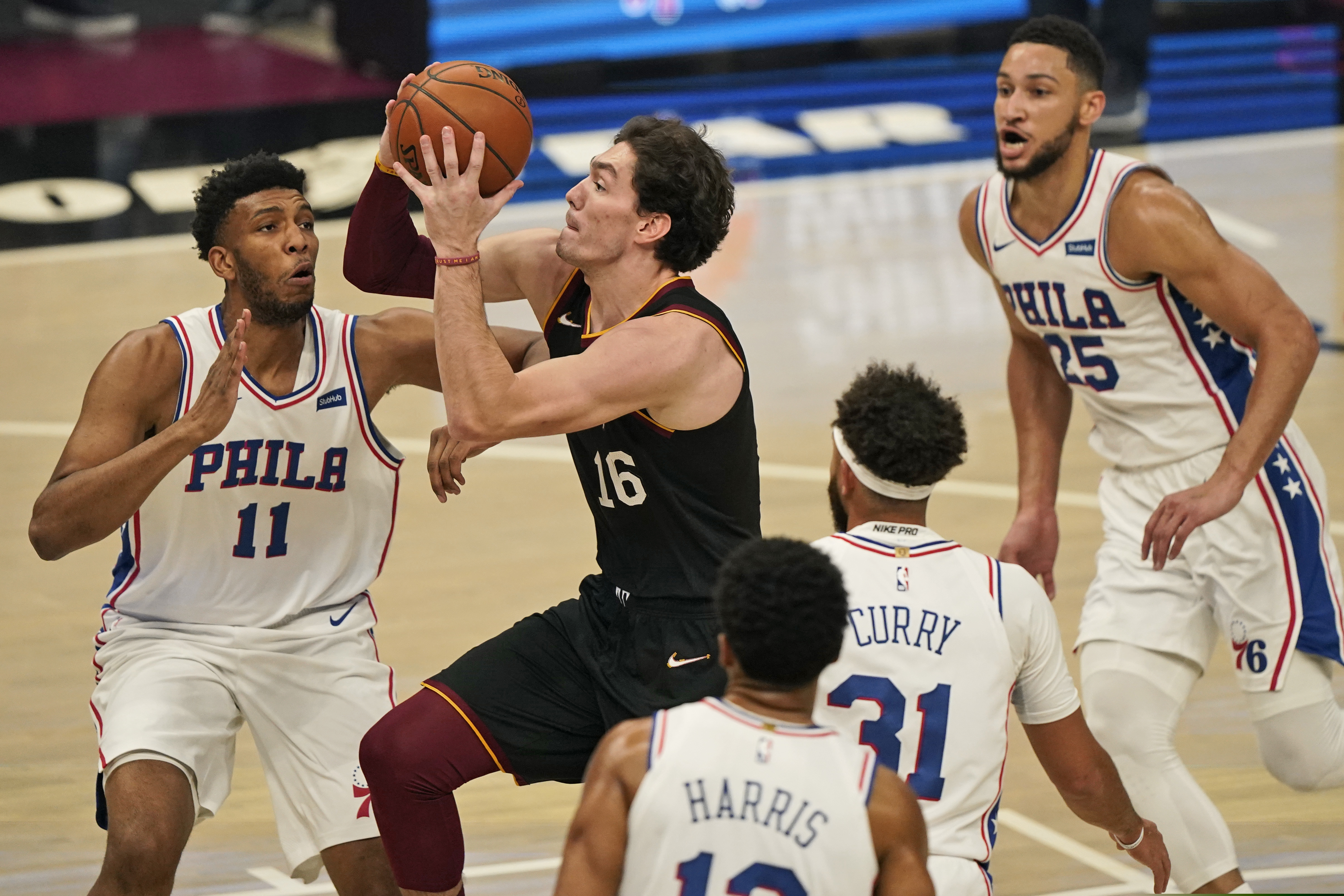 The Cavaliers' Cedi Osman (16) drives to the basket against the Sixers.