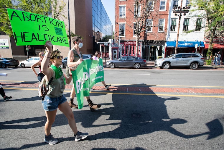 A group of approximately 25 abortion right supporters march down E. Market St. following a labor rally on Independence Mall on Aug. 20, 2022.