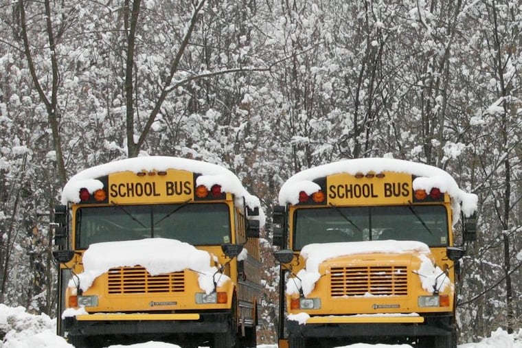 School buses parked in the snow.