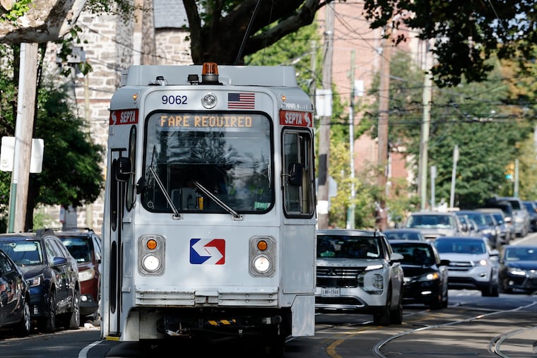 Soon, SEPTA trolleys will have "eyes," enforcement cameras to catch parkers who impede them. Pictured is a trolley rolling on Baltimore Avenue in West Philadelphia last summer.