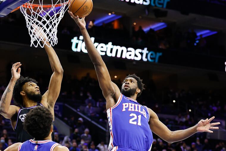 Sixers center Joel Embiid attempts to lay-up the basketball against Sacramento Kings forward Marvin Bagley III during the first quarter on Saturday, January 29, 2022 in Philadelphia.