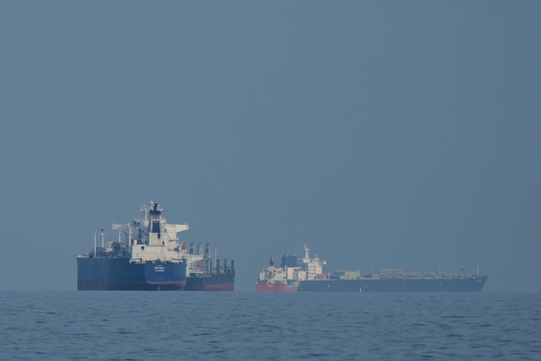 Oil tankers and cargo ships line up in the Strait of Hormuz, as seen from Khor Fakkan, United Arab Emirates, on March 11.