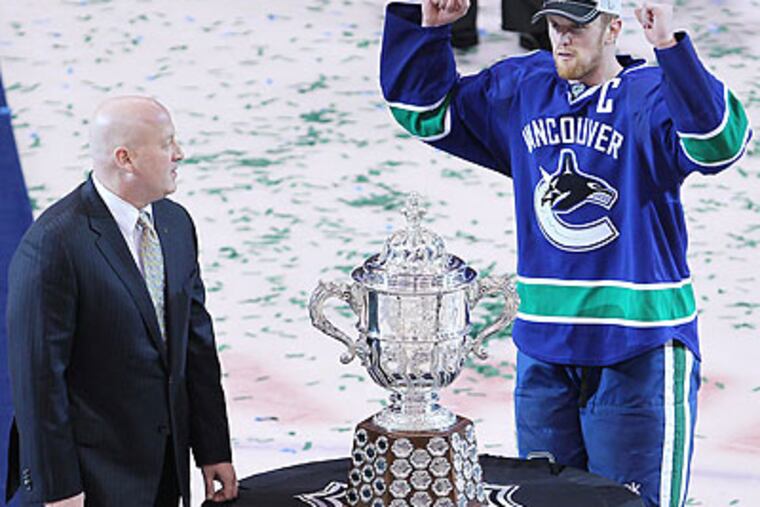 A superstitious Henrik Sedin refused to touch the Campbell Trophy after the presentation. (Jonathan Hayward/Canadian Press/AP)