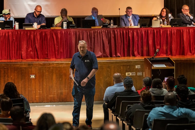 Scott Polk, an honors and AP English teacher in the Coatesville Area School District, goes back to his seat after speaking in support of suspended seventh grade special education and English language arts teacher Audra Ritter during a school board meeting Tuesday night.