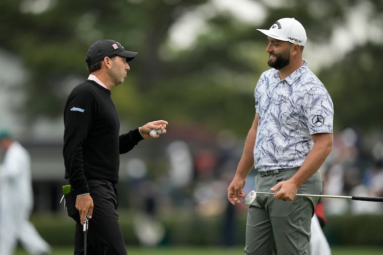 Sergio Garcia speaks with fellow Spaniard Jon Rahm at Augusta National before the 2023 Masters.