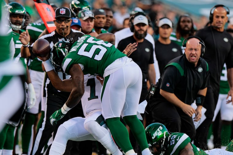 New York Jets defensive end Jermaine Johnson (52) hits Philadelphia Eagles quarterback Jalen Hurts (1) late during the first quarter of the during the Philadelphia Eagles preseason game against the New York Jets in Philadelphia, PA on Friday, August 12, 2022. New York Jets defensive end Jermaine Johnson (52) called for a penalty of unnecessary roughness on Hurts.