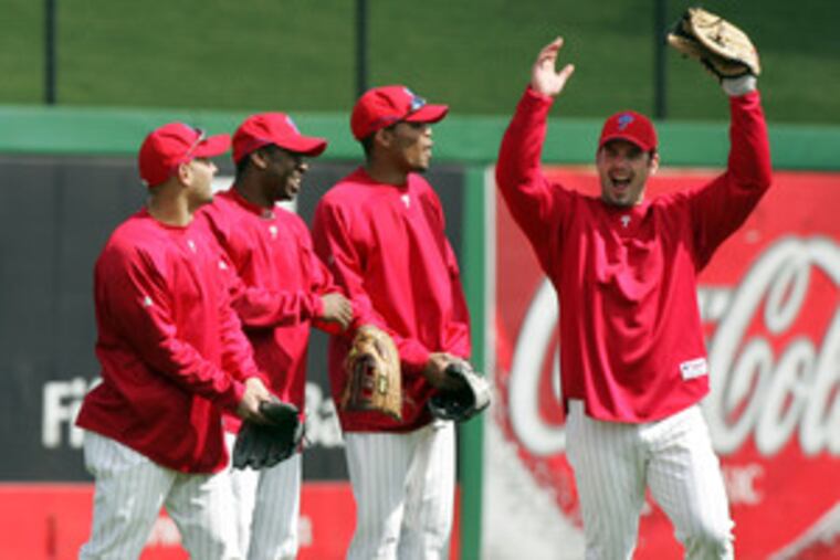 Aaron Rowand (right) gives the Phillies a sense of fun the team has often lacked. Here he has the eye of, from left, Shane Victorino, Michael Bourn and Chris Roberson after a spring-training workout. Rumors have Rowand being shopped for a relief pitcher.