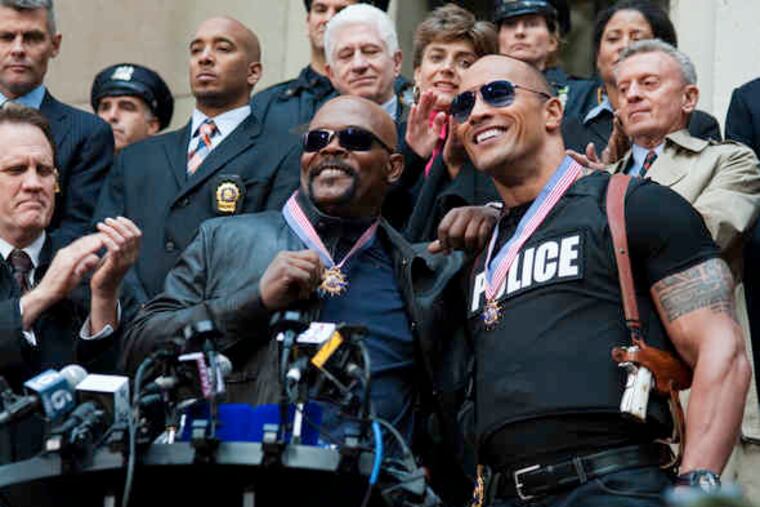 Samuel L. Jackson (center) and Dwayne Johnson (right) play high-profile detectives, unlike Ferrell and Wahlberg.