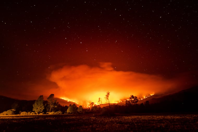 In this Sept. 16 photo, the August Complex Fire burns near Lake Pillsbury in the Mendocino National Forest, Calif.
