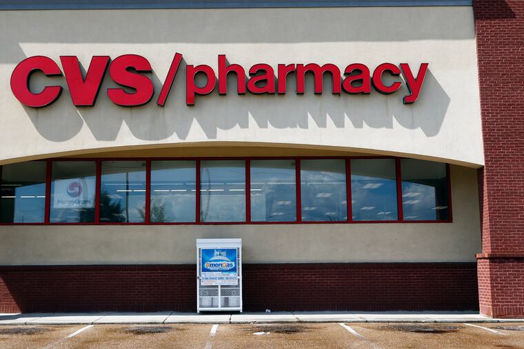 FILE- In this Aug. 7, 2018, file photo a CVS Pharmacy building sign rests on a store.