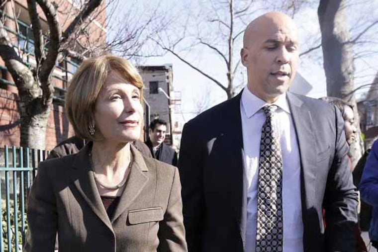 New Jersey Democratic Sen. Barbara Buono, left, walks with Newark Mayor Cory Booker during a walk through Newark's Ironbound neighborhood during a listening tour to talk to residents, Tuesday, March 19, 2013, in Newark, N.J. Buono will be challenging Gov. Chris Christie during the gubernatorial race. (AP Photo/Julio Cortez)