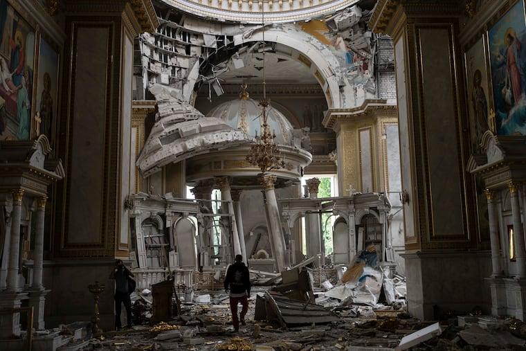 Church personnel inspect damages inside the Transfiguration Cathedral in Odesa, Ukraine, on Sunday, following a Russian missile attack.