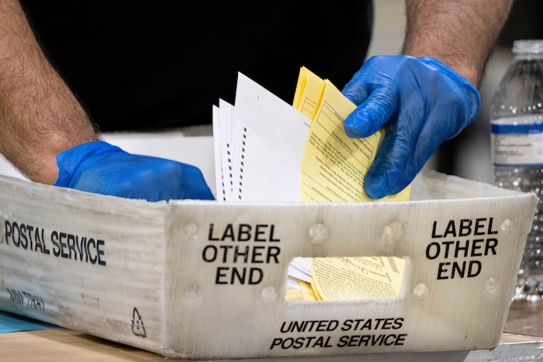 Elections workers process absentee ballots in 2021