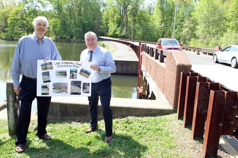 BUDGETS13P.(L-R) Freehold Borough Councilmen Ron Griffiths and Kevin Kane at the site of the proposed pedestrian bridge over Lake Topanemus, Freehold, NJ. Citizens voted to fund the building of the bridge through the process of participatory budgeting.