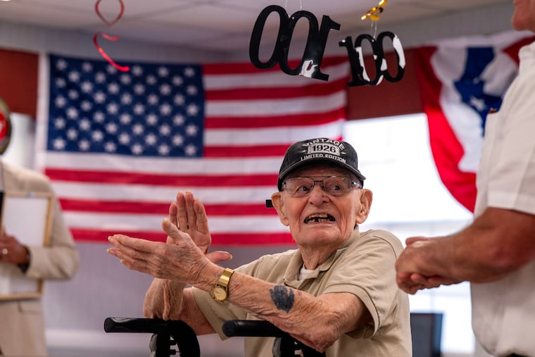 WWII U.S. Marine Corps (and U.S. Air Force) veteran Stephen Anderson is surprised by fellow vets who show up for his 100th birthday party Tuesday at the Wynwood Rehabilitation & Healthcare Center in Cinnaminson.
