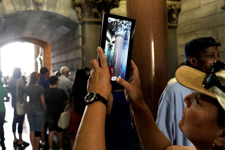 A visitor photographs inside the North Central Portal. Tours are offered daily, with some reaching the tower's top.