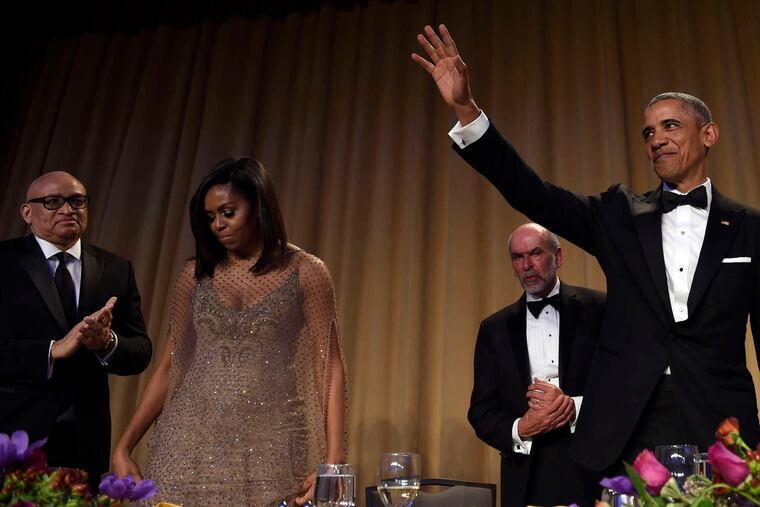 President Obama waves after speaking at the annual White House Correspondents' Dinner at the Washington Hilton, where he was joined by comedian Larry Wilmore (left), Michelle Obama, and Jerry Seib of the Wall Street Journal.