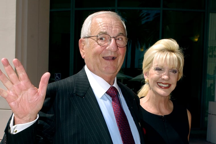 FILE - Lee Iacocca waves as he and Patricia Kennedy arrive at the Academy of Television Arts and Sciences headquarters in Los Angeles' North Hollywood area Wednesday, Aug. 27, 2003. (AP Photo/Reed Saxon)