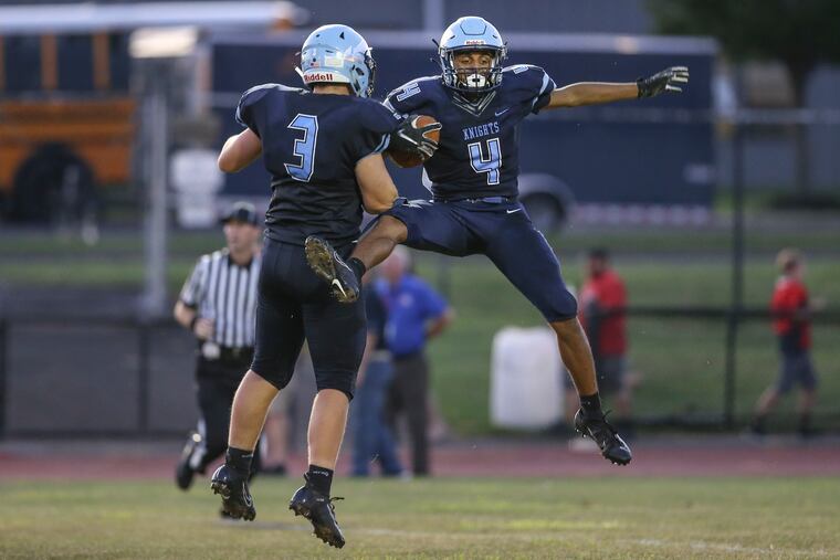 North Penn's Kenneth Grandy (4) celebrates his 69 yard TD pass against Neshaminy with teammate Cory Keim (3) during the 2nd quarter in Lansdale.