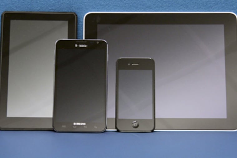 The Samsung Galaxy Note (second from left) with (from left) Kindle Fire, iPad, iPhone 4. (Elizabeth Robertson / Staff Photographer)