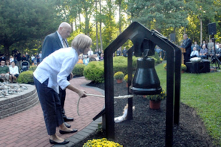 Nicholas and Nancy Brandemarti, whose son, Nick, was killed in the terrorist attacks of Sept. 11, 2001, ring a bell at Mantua's 9/11 memorial to mark the moment when the second plane hit.