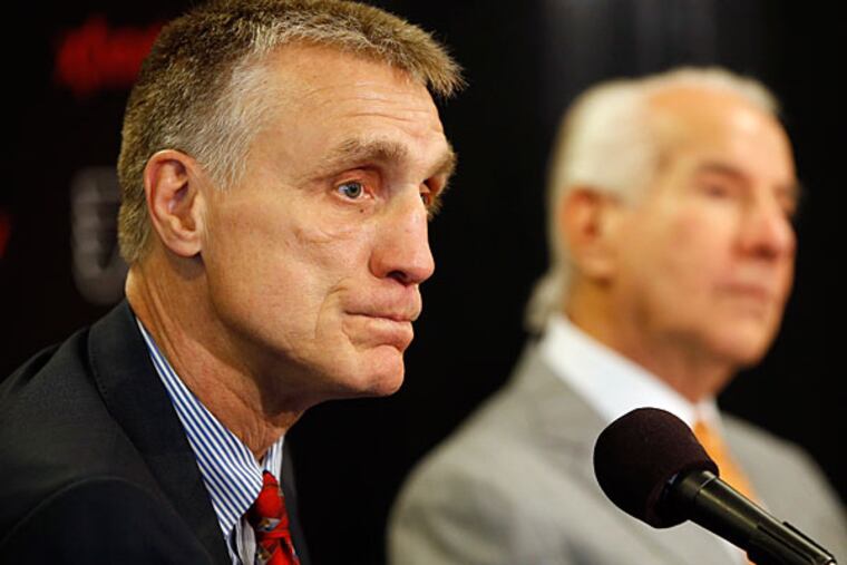 Paul Holmgren, left, listens to a reporter's question as chairman Ed Snider looks on during an NHL hockey news conference, Wednesday, May 7, 2014, in Philadelphia. (Matt Slocum/AP)