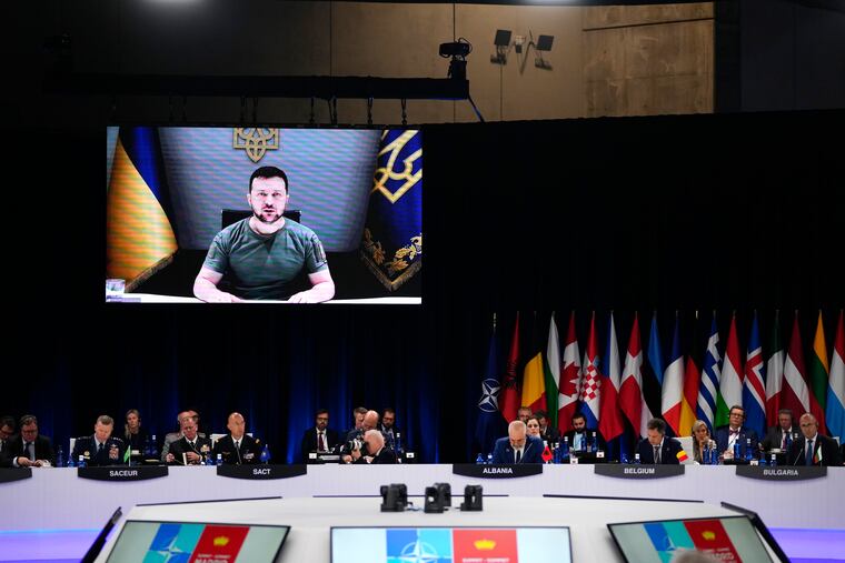 Ukraine's President Volodymyr Zelenskyy addresses leaders via a video screen during a round table meeting at a NATO summit in Madrid on Wednesday.