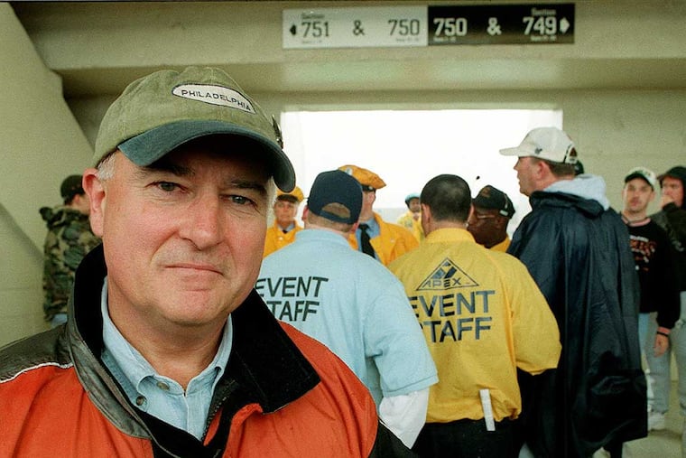 Eagles' Court Judge Seamus McCaffery patrols the 700 level during the game to see if cops are arresting people breaking the law. Here he poses in front of security who are escorting someone out of the game. Andrea Mihalik / Philadelphia Daily News
