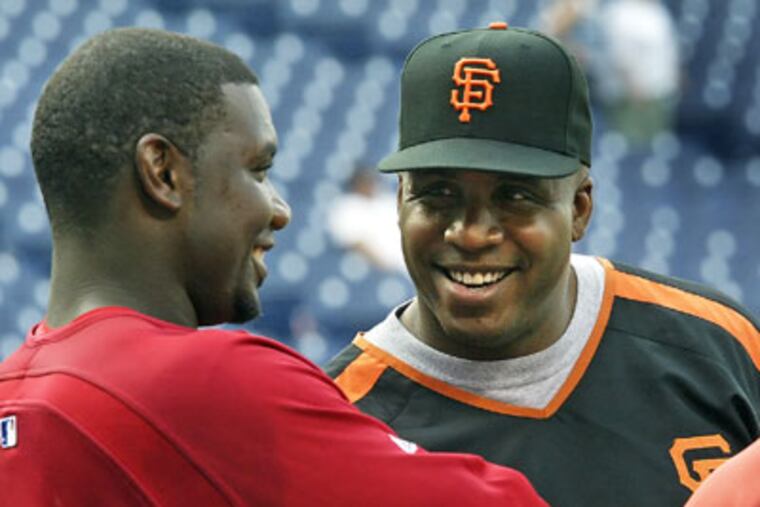Growing up, Ryan Howard (left) idolized Barry Bonds. (Steven M. Falk / Staff Photographer)