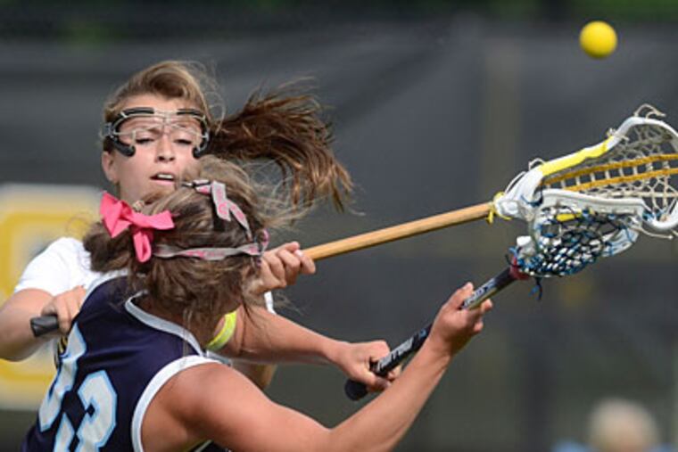 Moorestown's Megan Kelly, rear, battles Shawnee's Caroline Shinske for control fo the ball. (Tom Gralish/Staff Photographer)