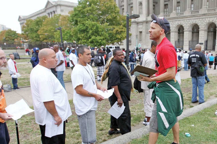 Adam Bruckner of Philly Restart explains the proper protocol for receiving a check on Vine Street between 18th and 19th streets in Center City on Monday, September 29, 2014. ( YONG KIM / Staff Photographer )