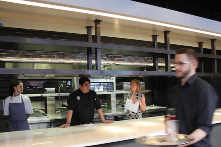 In the kitchen-slash-dining room at Volver are (from left) chef de cuisine Natalie Maronski, chef Jose Garces and designer Marguerite Rodgers.