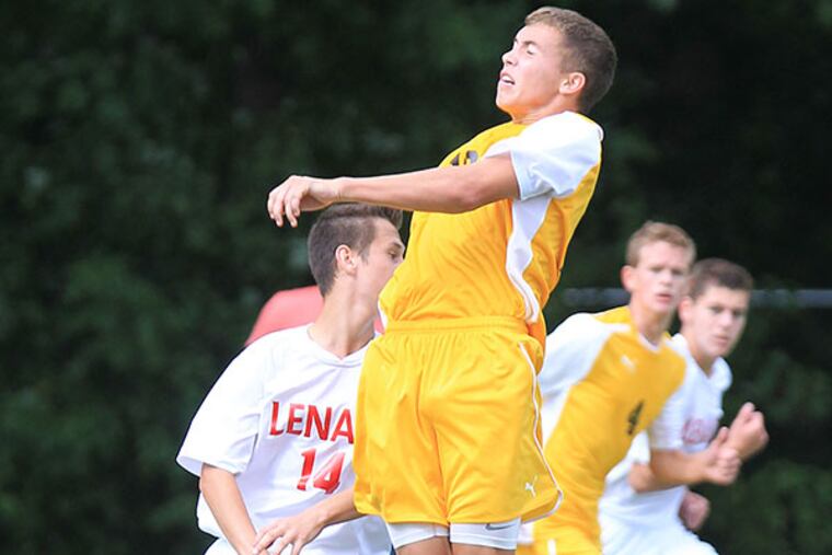 Michael Strohlein, center, of Delran goes up to head a ball against Lenape in the first half. Josh Dawicki of Lenage is left.