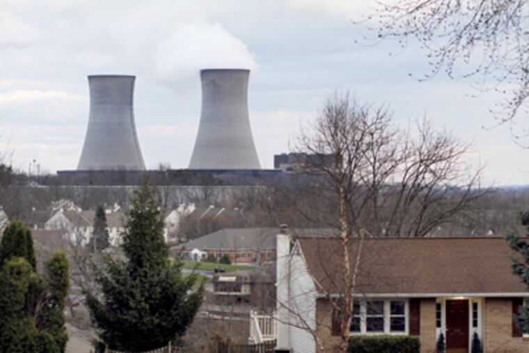 The Limerick nuclear plant’s cooling towers loom behind a house on Winding Road in Pottstown.