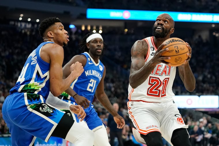 Miami Heat's Dewayne Dedmon (21) looks to shoot against Milwaukee Bucks' Giannis Antetokounmpo during the first half of an NBA basketball game Saturday, Feb. 4, 2023, in Milwaukee.