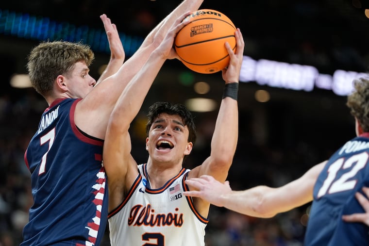 Illinois guard Andrej Stojakovic (center) is defended by Penn's Michael Zanoni (left) during the first half in the first round of their NCAA Tournament matchup.