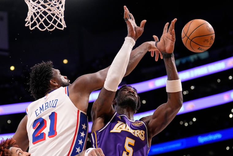 Sixers center Joel Embiid (left) blocks Los Angeles Lakers center Deandre Ayton's shot during the second half of their 119-115 loss.