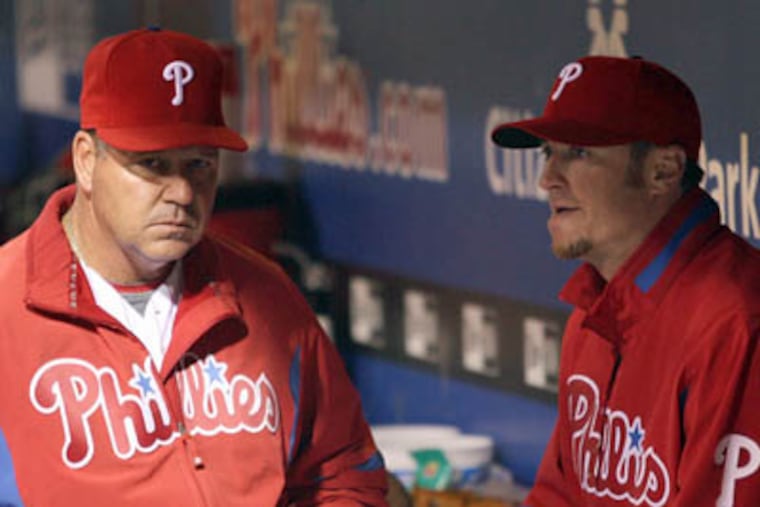 Former Phillies pitching coach Rich Dubee, left, talks with right-hander Brett Myers in the dugout during a game in 2009.