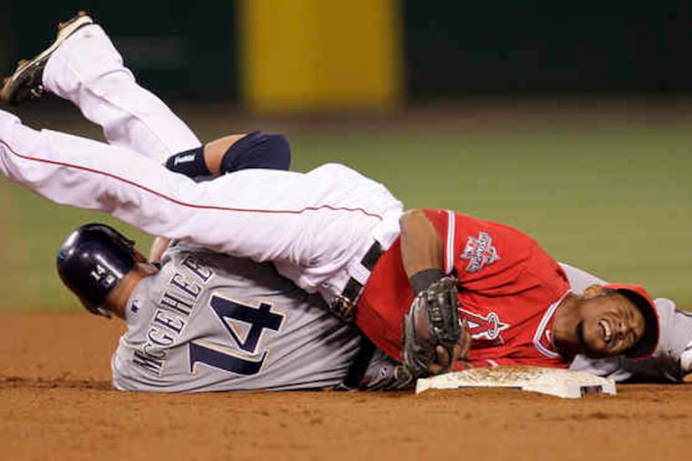 Erick Aybar of the hard-luck Angels grimaces after the Brewers' Casey McGehee slides into him to break up a double play.