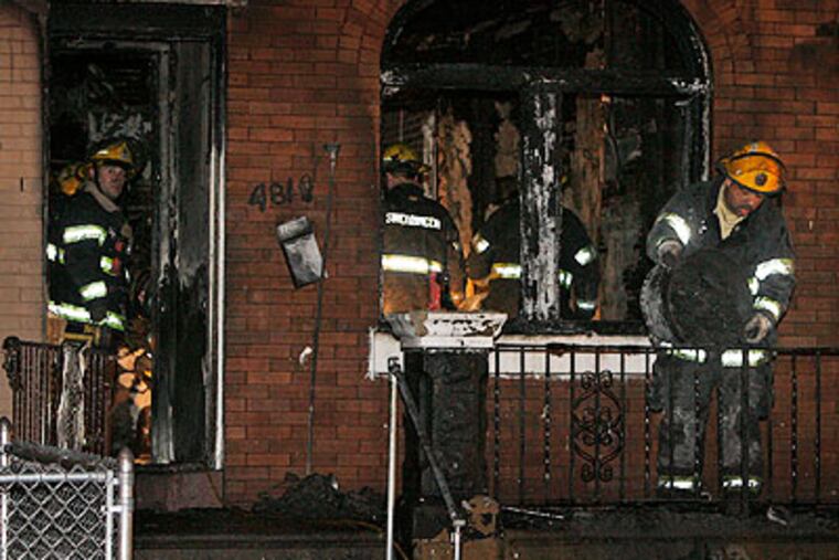 Philadelphia firemen remove debris as they investigate a fatal fire in the 4800 block of North Palethorpe Street near Roosevelt Boulevard on Thursday morning. (Alejandro A. Alvarez / Staff Photographer)