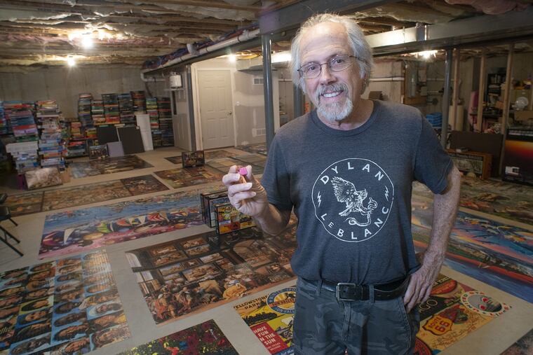 Larry Blanck talks about his puzzle-solving ability in the basement of his Warminster home that is dominated by huge jigsaw puzzles laid out on the floor.