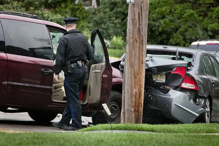 Philadelphia police officers at the scene of Wednesday morning’s fatal shooting in the 6300 block of Overbrook Avenue.