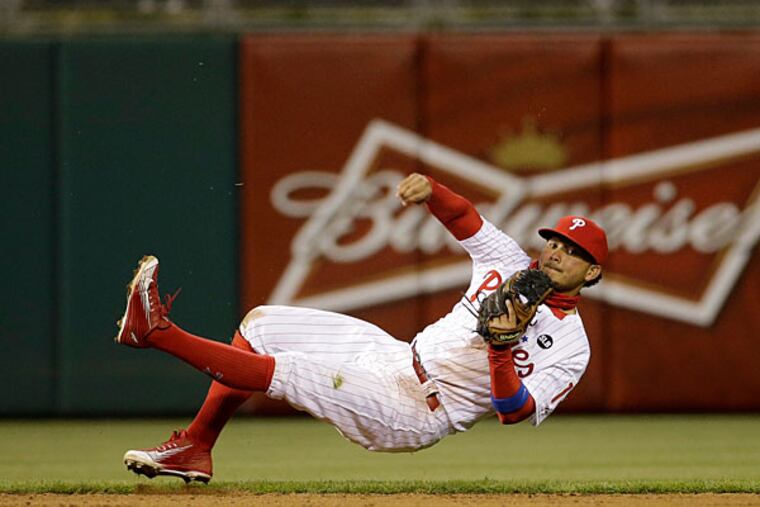 Philadelphia Phillies shortstop Freddy Galvis throws to first base for the out on a grounder by Atlanta Braves' Nick Markakis during the sixth inning of a baseball game, Saturday, April 25, 2015, in Philadelphia. Atlanta won 5-2. (Matt Slocum/AP)