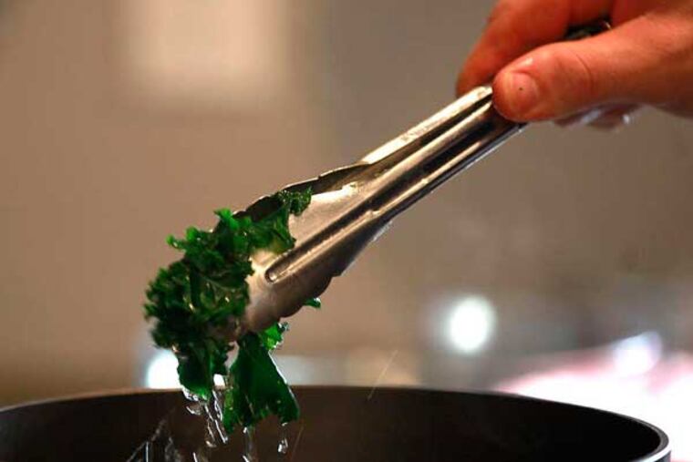 Kale is blanched to keep its bright green color, and pairs with oranges at Christine Sheller and Paul Hedman’s vegan holiday table. “We are definitely not deprived,” says Sheller DAVID SWANSON / Staff Photographer