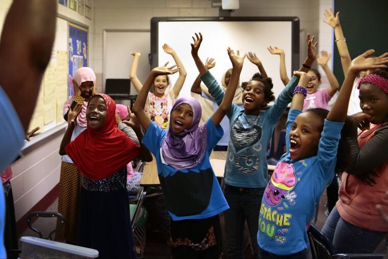 After making a craft, students sing and dance at a Girl Scout activity at Nahed Chapman New American Academy on Thursday, May 18, 2017.