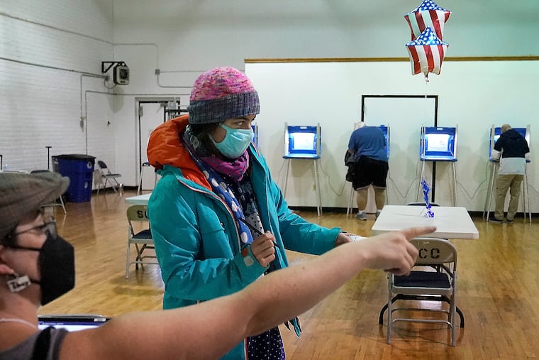 Monica Rojas gets directions from a poll worker on her way to casting her ballot at Sabathani Community Center during municipal elections Tuesday, Nov. 2, 2021, in Minneapolis. Voters in Minneapolis are deciding whether to replace the city’s police department with a new Department of Public Safety. The election comes more than a year after George Floyd’s death launched a movement to defund or abolish police across the country.(David Joles /Star Tribune via AP)