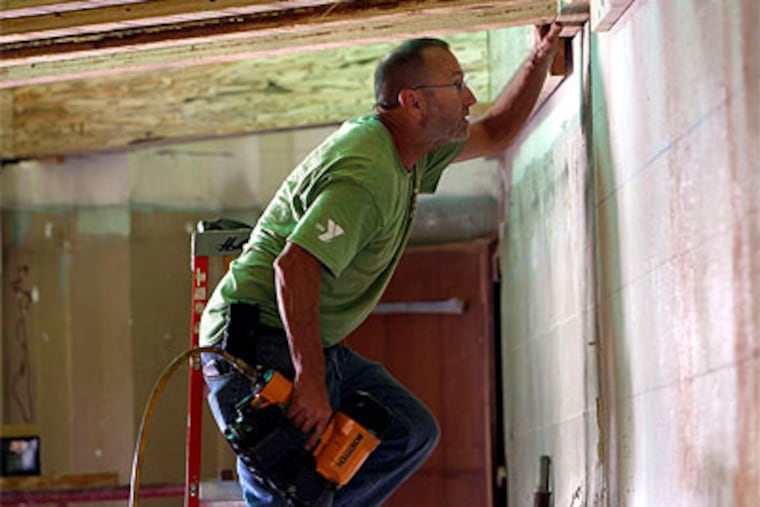 Paul Willman , a volunteer from Boyertown, Pa., helps on the dining hall project. (David Maialetti / Staff Photographer)